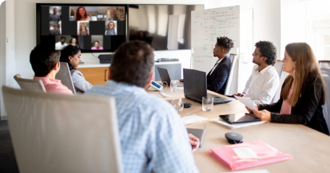 People in a conference room on a video call