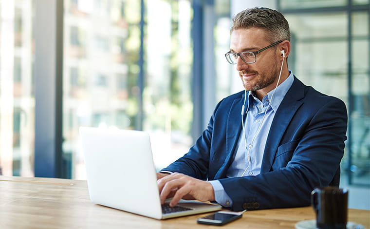 Person with a beverage using a laptop