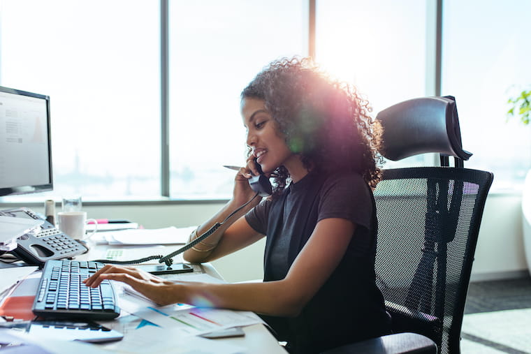 An employee uses her phone to conduct business