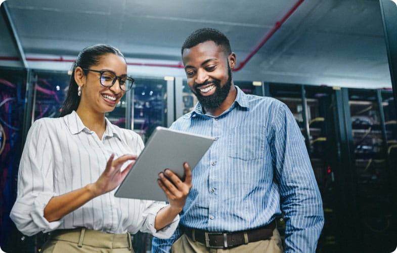 Two people using a table in a warehouse