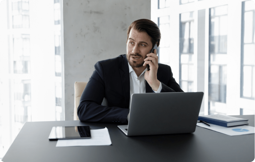 employee with laptop on phone
